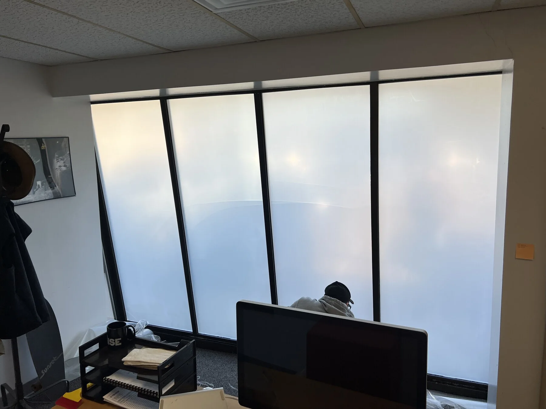Frosted privacy glass beside office workstations